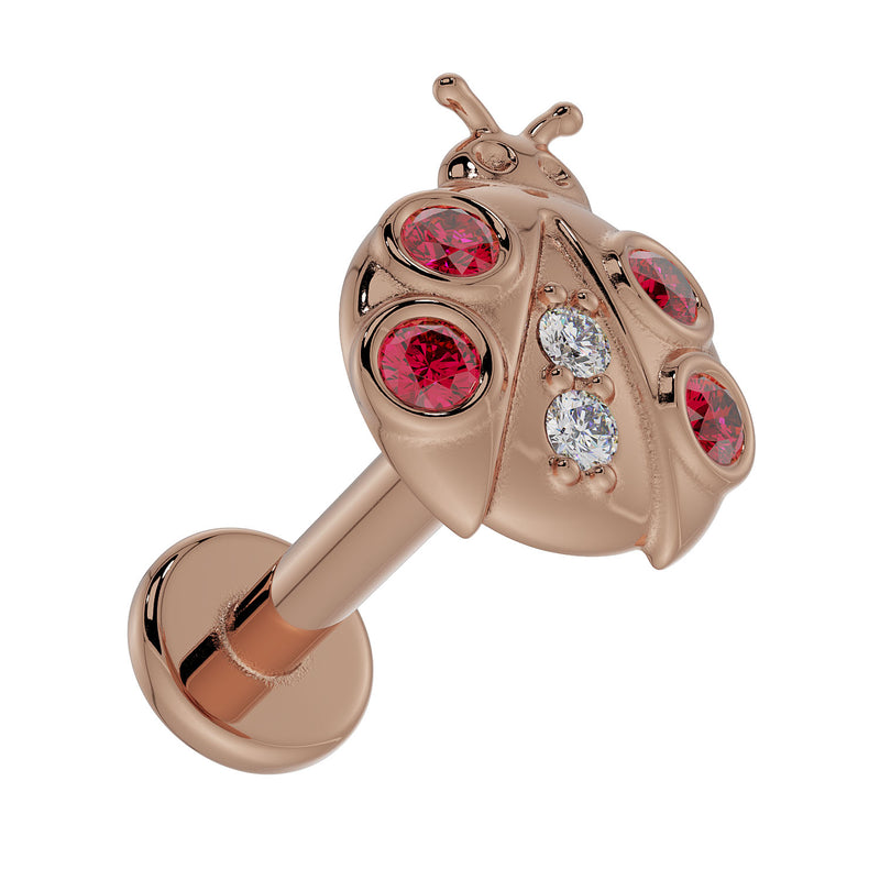 14K rose gold ladybug labret stud, overhead angle showing full post and flat back disc with garnet and diamond