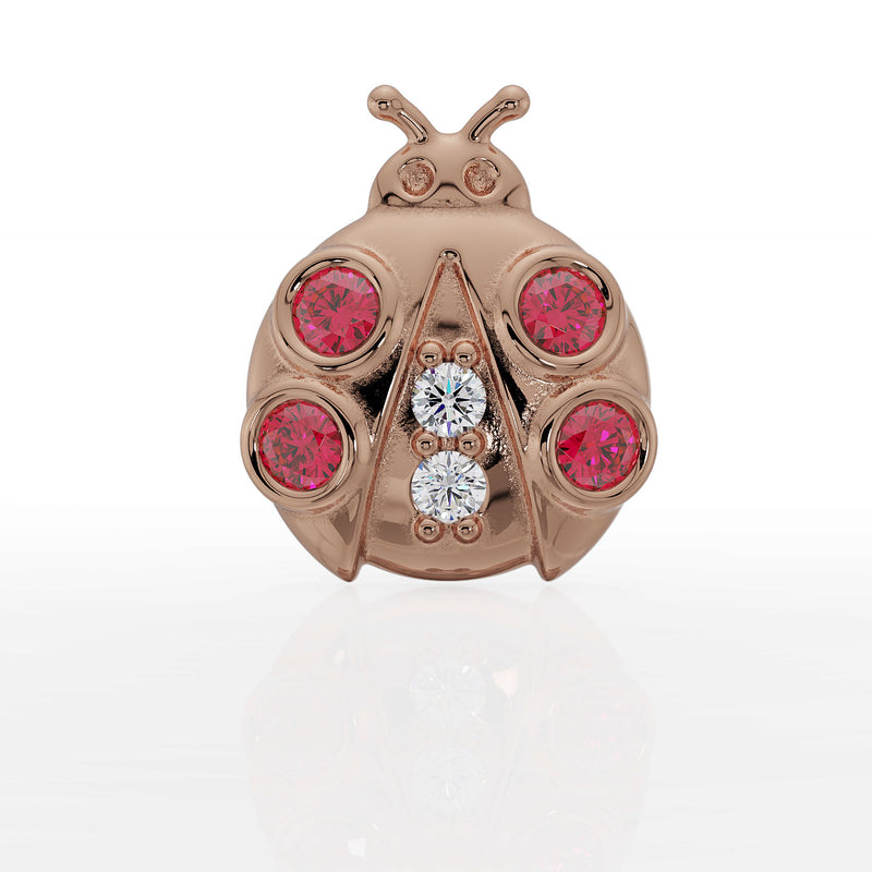 14K rose gold ladybug flat back stud, straight-on front view showing garnet bezel spots and two center diamonds