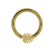 14K yellow gold monstera leaf seam ring hoop, front view showing textured leaf charm detail