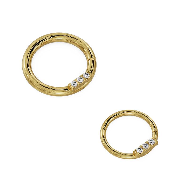 Two sizes of 14K yellow gold trinity diamond seam ring shown side by side for scale comparison