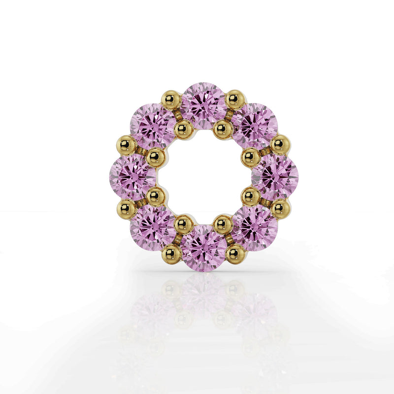 Close-up front view of 14K yellow gold open circle pink sapphire halo charm, prong detail visible