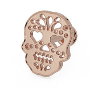 14K rose gold Dia de los Muertos skull flat back labret, angled view showing warm pink-gold tone