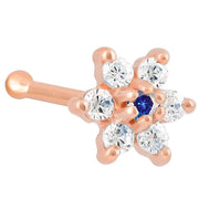 14K rose gold flower nose bone with blue sapphire CZ center and clear CZ petals, angled view