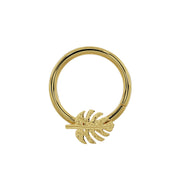 14K yellow gold monstera seam ring with leaf charm positioned at bottom center, slightly larger diameter view