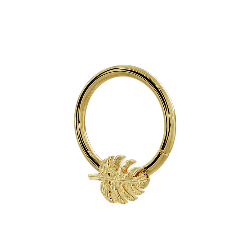 Side-angled view of 14K yellow gold monstera leaf seam ring showing hoop depth and leaf charm relief