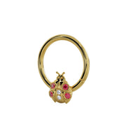 14K yellow gold ladybug seam ring, angled view showing garnet and diamond charm from a slight angle