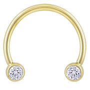 14k yellow gold circular barbell with dual bezel-set CZ ends, front view on white background
