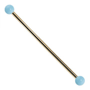 14K yellow gold industrial barbell with simulated turquoise ball ends, 14G straight barbell front view