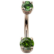 14k rose gold navel ring with dark green CZ stones in claw prong settings, front view