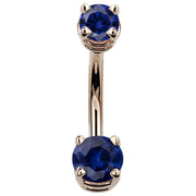 14k rose gold belly button ring with deep blue CZ stones in prong settings, front view