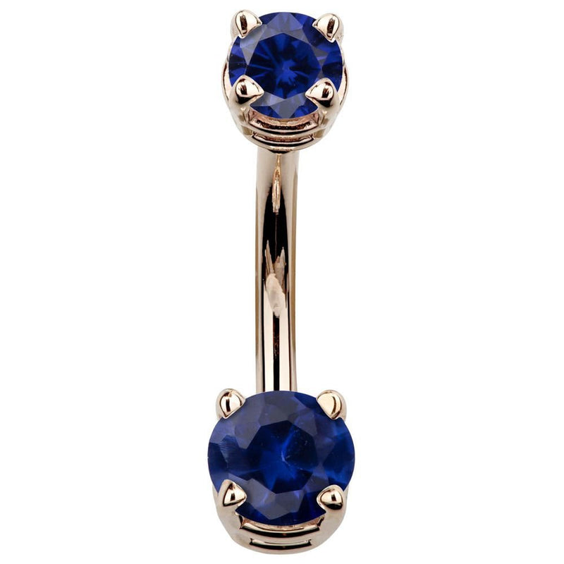 14k rose gold belly button ring with deep blue CZ stones in prong settings, front view
