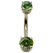 14k yellow gold belly button ring with dark green round CZ gems in claw settings, front view