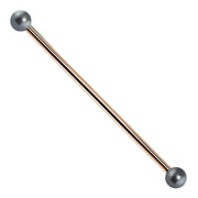 14K rose gold industrial barbell with cultured peacock pearl ends, front view
