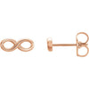 14K rose gold infinity stud earrings angled to show slim profile and butterfly push-back clasp