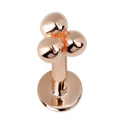 14k rose gold trinity bead flat back labret stud, front view with warm-toned polished three-bead top