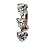 14K rose gold reverse navel ring featuring three heart-cut CZ charms in prong settings, side view