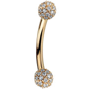 14K yellow gold curved barbell with diamond pavé 4mm balls, side view showing warm gold tone