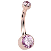 14K rose gold belly ring with dual bezel-set pink CZ stones, angled side profile view