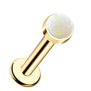 14k yellow gold flat back labret stud with 2mm white opal cabochon in bezel setting, front view