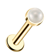 14k yellow gold flat back labret with 2mm genuine pearl cabochon in bezel setting, angled view