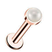 14k rose gold flat back labret with 2mm pearl cabochon in bezel setting, angled product view