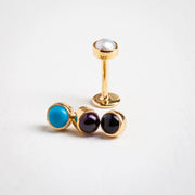 14k yellow gold pearl flat back stud shown alongside turquoise, amethyst, and onyx cabochon variants