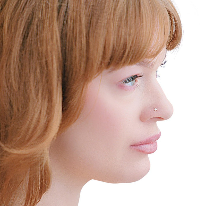 Side profile of model wearing 2mm diamond nose stud, showing delicate low-profile fit on nose