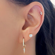 Marquise diamond lotus flat back stud worn in helix piercing, styled with lobe and hoop earrings