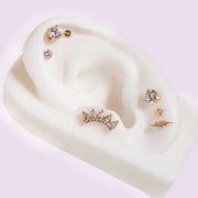 3mm diamond bezel flat back stud on white ear mannequin styled with mixed gold cartilage jewelry