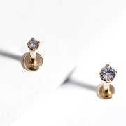 Two 14k gold 3mm CZ flat back labret studs shown upright on white surface, showcasing basket setting height
