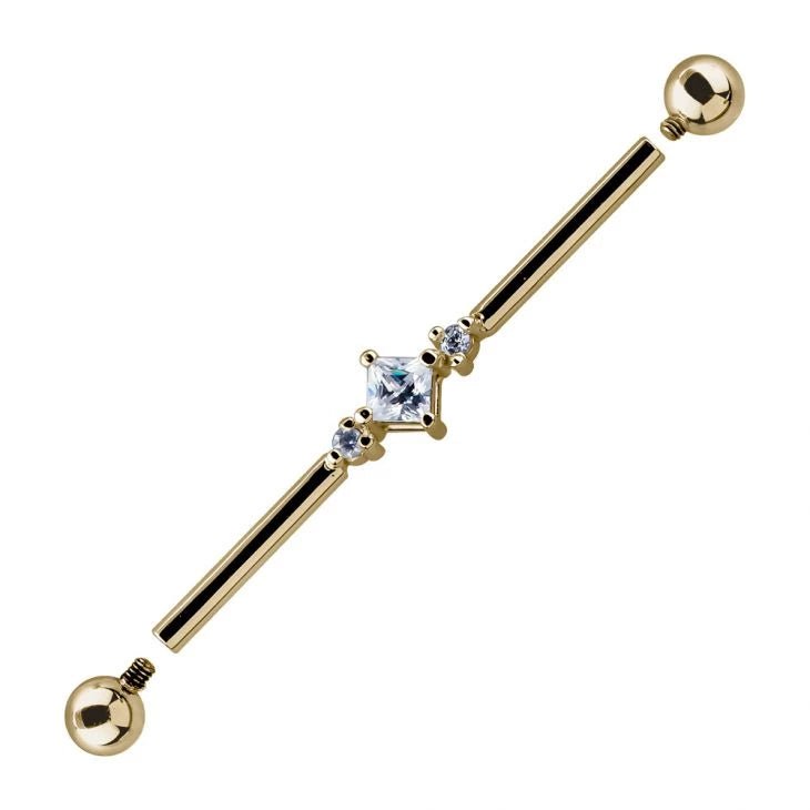 14K yellow gold triple CZ industrial barbell with detached threaded ends, close-up of prong-set CZ cluster