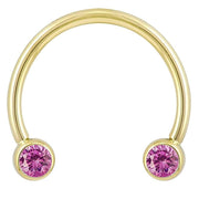 14k yellow gold circular barbell with pink CZ bezel ends, smaller diameter front view