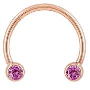 14k rose gold circular barbell with pink CZ bezel ends, smaller diameter showing warm gold tone