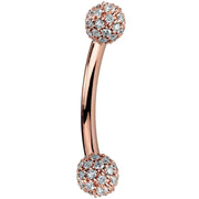 14K rose gold curved barbell with diamond pavé 4mm balls, warm blush tone side profile view