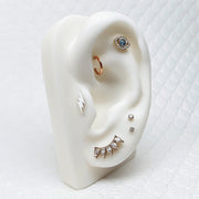 Diamond flat back labret stud on white ear display mannequin showing helix and lobe placement