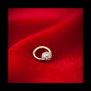 14K yellow gold diamond pavé ball fixed bead ring resting on red velvet, lifestyle product shot
