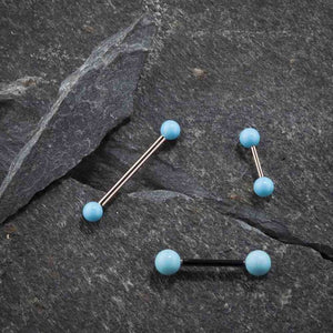 Multiple simulated turquoise straight barbells in varied metal tones displayed on dark slate stone surface