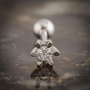 Close-up of 14k white gold diamond flower helix stud showing six-prong petal setting and diamond center
