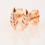 14k rose gold feather stud earrings pair shown at angle, revealing butterfly push-back backing