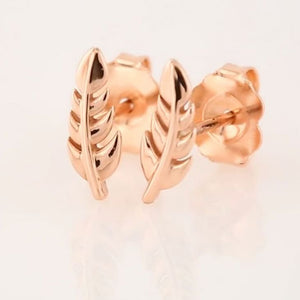 14k rose gold feather stud earrings pair shown at angle, revealing butterfly push-back backing