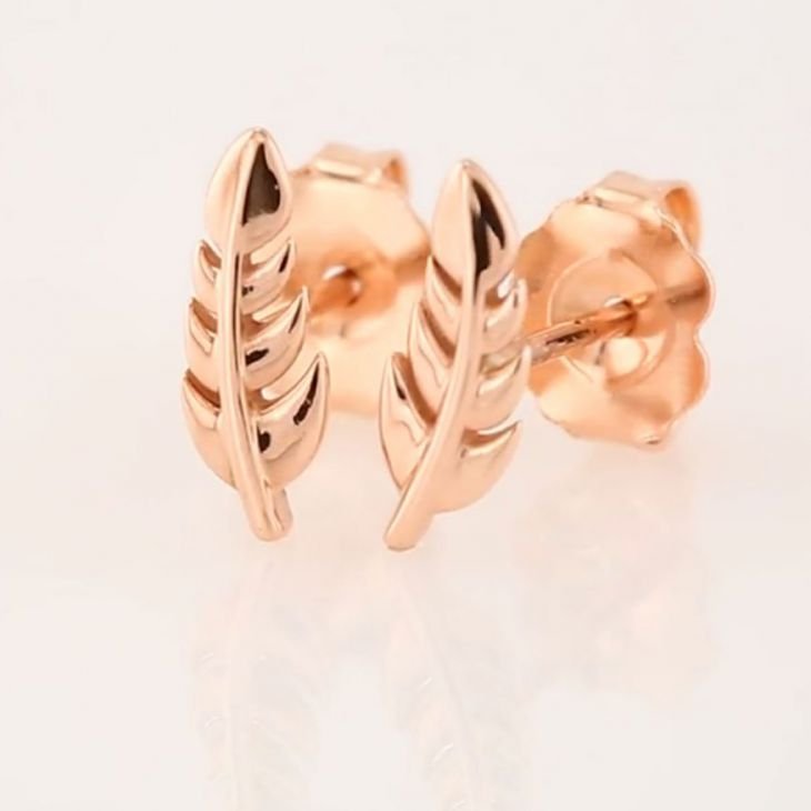 14k rose gold feather stud earrings pair shown at angle, revealing butterfly push-back backing