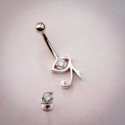 14k rose gold Eye of Horus navel ring with internally threaded bottom shown separately, styled flat lay
