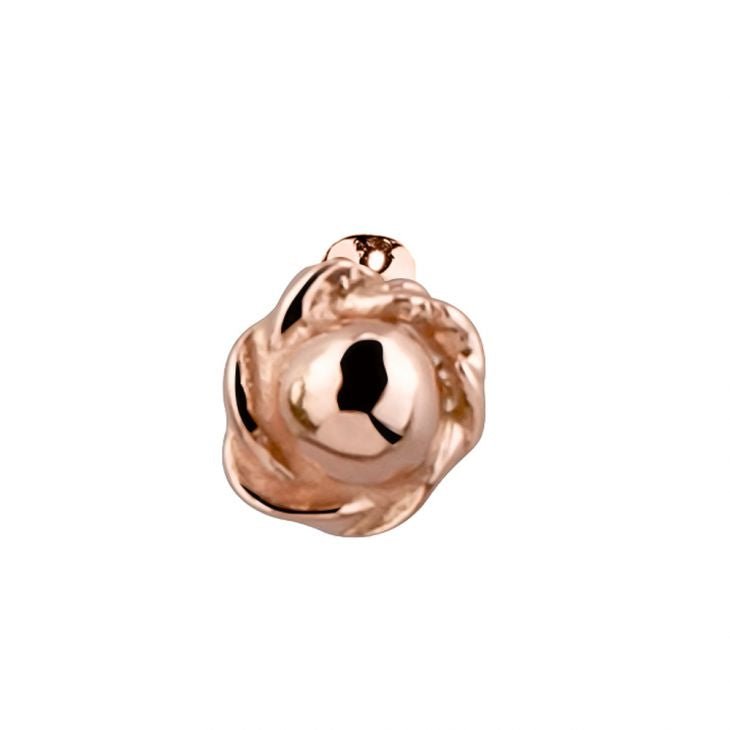 Close-up of 14K rose gold rose bud nose stud charm showing detailed petal texture and domed center