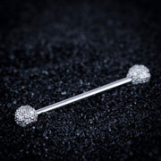14k white gold diamond pavé straight barbell resting on dark textured surface, angled lifestyle shot