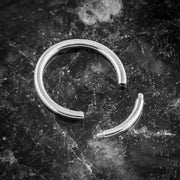 14K white gold segment ring open on dark marble, showing segment closure and ring profile