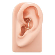 14K yellow gold moon seam ring worn in rook piercing on silicone ear model for fit reference
