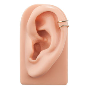 Two band 14k gold ear cuff worn on the helix of a silicone ear model