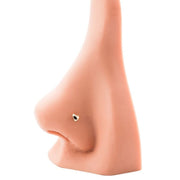 Dainty 14k gold puffy heart nose ring shown in piercing on nose model for fit and scale