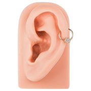14K gold diamond flower clicker ring styled in a helix or daith ear piercing on ear model