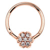 14K rose gold hinged clicker ring with 7-diamond pavé flower charm, front view on white